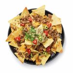 Corn chips nachos with fried minced meat and guacamole isolated